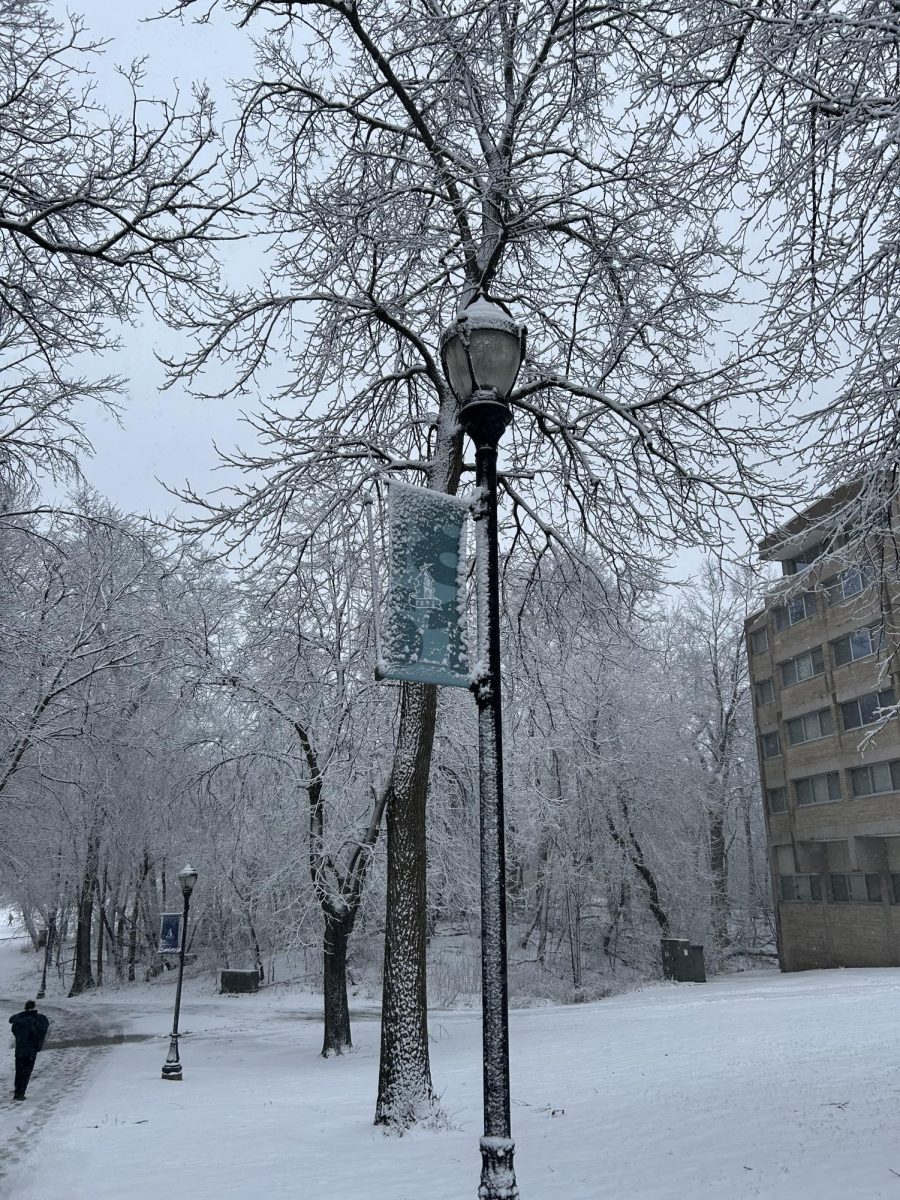 The ice and snow freezes on the posted signage all over campus, including in front of Scott Hall.