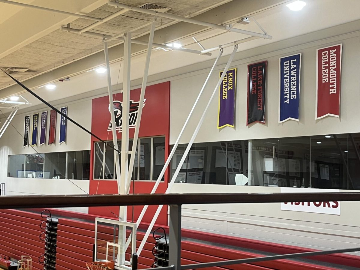 The nine teams in the Midwest Conference will be receiving an addition in Luther College” or just a basic description of the photo like “The institution banners of the nine teams in the Midwest Conference hang in Weiske Gym, with Luther College being the new, tenth team.